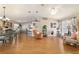 Bright living space with wood floors, ceiling fan, and dining area for seamless entertaining at 173 Juniper Way, Ocala, FL 34480