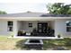 Spacious backyard view from covered patio with fire pit and lush landscaping at 18 Larch Radl, Ocala, FL 34480