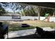 View of fenced backyard with white rock landscaping, trampoline, playset, and in-ground fire pit at 18 Larch Radl, Ocala, FL 34480