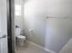 Bathroom featuring a toilet, walk-in shower, and window providing natural light at 18 Larch Radl, Ocala, FL 34480