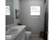 Well-lit bathroom featuring a gray countertop vanity, toilet, decor, and window at 18 Larch Radl, Ocala, FL 34480