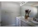 Well-lit bathroom featuring a double sink vanity, framed mirror and neutral color palette at 18 Larch Radl, Ocala, FL 34480