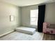 Cozy bedroom with a large window, an area rug and natural light at 18 Larch Radl, Ocala, FL 34480