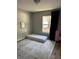 Cozy bedroom with a large window, an area rug and natural light at 18 Larch Radl, Ocala, FL 34480