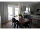 Bright dining area featuring modern lighting, gray cabinetry, and outdoor access at 18 Larch Radl, Ocala, FL 34480