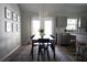 Bright dining room with modern chandelier, gray cabinets, and wood-look vinyl flooring at 18 Larch Radl, Ocala, FL 34480