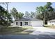 Beautifully renovated home with a manicured front yard and a two-car garage at 18 Larch Radl, Ocala, FL 34480