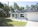 Lovely single-story home with well-manicured lawn, updated windows and stylish front door at 18 Larch Radl, Ocala, FL 34480