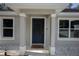 Close up of front door with decorative wreath and sidelight windows at 18 Larch Radl, Ocala, FL 34480