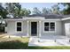 Inviting front entrance featuring a modern door with white rock landscaping at 18 Larch Radl, Ocala, FL 34480