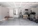 Spacious garage featuring concrete floors, water heater, storage, and a treadmill at 18 Larch Radl, Ocala, FL 34480