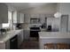 A kitchen featuring gray cabinets, stainless steel appliances, a gold faucet, and a central island at 18 Larch Radl, Ocala, FL 34480