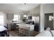 A modern kitchen with gray cabinets, an island with seating, and stainless steel appliances at 18 Larch Radl, Ocala, FL 34480