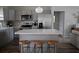 An open-concept kitchen featuring an island with bar seating and stainless steel appliances at 18 Larch Radl, Ocala, FL 34480