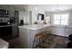 A kitchen with a view of the living room, featuring an island with bar stools at 18 Larch Radl, Ocala, FL 34480