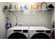 Laundry room with front loading Whirlpool washer and dryer and wire shelving at 18 Larch Radl, Ocala, FL 34480