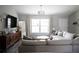 Cozy living room featuring a large sectional sofa, wooden cabinet and decor at 18 Larch Radl, Ocala, FL 34480