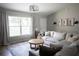 Bright living room featuring a large window, stylish rug, and a comfortable neutral-toned sectional at 18 Larch Radl, Ocala, FL 34480