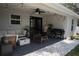 Cozy covered patio featuring a grill, fire pit, furniture, and ceiling fan at 18 Larch Radl, Ocala, FL 34480