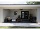 Covered patio furnished with cozy seating, string lights, and outdoor grill at 18 Larch Radl, Ocala, FL 34480