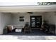 Relaxing covered patio with stylish furniture, fire pit, ceiling fan and string lights at 18 Larch Radl, Ocala, FL 34480