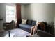 Salon room with a gray sofa, styling chair, throw blanket, decor, and a bright window at 18 Larch Radl, Ocala, FL 34480
