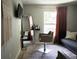 Salon room featuring a large mirror, styling chair, TV, decor, and a window for natural light at 18 Larch Radl, Ocala, FL 34480