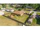 Bird's eye view highlights the house, a spacious fenced backyard, a deck with a pergola, and surroundings at 2045 Se 32Nd St, Ocala, FL 34471
