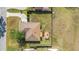 Aerial shot shows the expansive fenced-in backyard, wooden deck with pergola, and home's roof at 2045 Se 32Nd St, Ocala, FL 34471