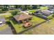 Aerial view showcases a well-maintained yard, wooden deck with pergola, and landscaping at 2045 Se 32Nd St, Ocala, FL 34471
