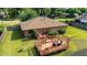 Aerial backyard view of the home reveals an inviting wood deck with a pergola and outdoor seating area at 2045 Se 32Nd St, Ocala, FL 34471