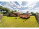 Expansive backyard features a wooden deck with a pergola, ideal for outdoor living and entertaining at 2045 Se 32Nd St, Ocala, FL 34471