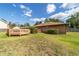 Backyard view of a wooden deck with a dining area, accessible from the yard at 2045 Se 32Nd St, Ocala, FL 34471