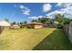 Rear view shows the home's exterior and the vastness of the green fenced backyard at 2045 Se 32Nd St, Ocala, FL 34471
