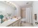 A well-lit bathroom with a single vanity sink, toilet, and tiled shower and tub at 2045 Se 32Nd St, Ocala, FL 34471