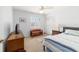 Comfortable bedroom with natural light streaming through large window, complemented by a ceiling fan and closet space at 2045 Se 32Nd St, Ocala, FL 34471