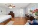 Spacious bedroom features light blue walls, wood flooring, ceiling fan, and large windows allowing natural light at 2045 Se 32Nd St, Ocala, FL 34471