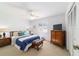 Bright bedroom with ceiling fan, neutral carpet, and a blue and white comforter at 2045 Se 32Nd St, Ocala, FL 34471
