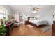 This cozy bedroom features hardwood floors, a ceiling fan, and a comfortably sized bed with patterned bedding at 2045 Se 32Nd St, Ocala, FL 34471
