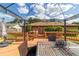 Large wooden deck with dining table and access to yard with trees at 2045 Se 32Nd St, Ocala, FL 34471