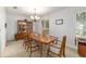 Formal dining room with hardwood table, chairs, and natural light from the windows at 2045 Se 32Nd St, Ocala, FL 34471