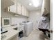 The laundry room has a sink, countertop, washer, dryer, and upper cabinets at 2045 Se 32Nd St, Ocala, FL 34471