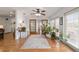 Bright living room featuring a ceiling fan, with lots of natural light from a large window at 2045 Se 32Nd St, Ocala, FL 34471