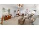 Bright living room with plush carpeting, ceiling fan and a decorative picture collage at 2045 Se 32Nd St, Ocala, FL 34471