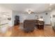 Open-concept living area with laminate flooring, ceiling fan, and adjacent kitchen at 2045 Se 32Nd St, Ocala, FL 34471