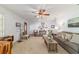 Open-plan living room with neutral colors, ceiling fan and a decorative picture collage at 2045 Se 32Nd St, Ocala, FL 34471