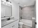 Modern bathroom featuring gray tiled shower, granite vanity, and updated fixtures at 24375 Nw Foxglove Ln, Dunnellon, FL 34431