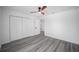 Bright bedroom featuring hard surface floors, a ceiling fan, and closet for ample storage at 24375 Nw Foxglove Ln, Dunnellon, FL 34431