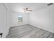Bedroom featuring wood-look flooring, a ceiling fan, and a bright window view at 24375 Nw Foxglove Ln, Dunnellon, FL 34431