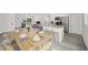 Elegant dining area open to living room and kitchen featuring modern decor and an island with bar seating at 24375 Nw Foxglove Ln, Dunnellon, FL 34431